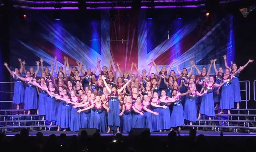 70-people chorus performing in our dresses